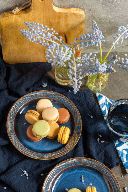 istock Macaroons and coffee. Dark blue plate, gray background. 945691108