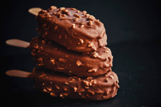 istock Vanilla Ice Cream with Chocolate on a Stick 945694558