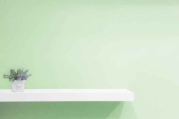 istock Empty white shop shelf, retail shelf on green vintage background. 945696454