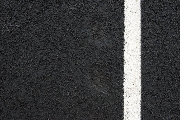 istock back road with white road marking and copy space seen from above 945709556