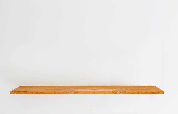istock Wooden shelf on concrete white wall. 945718118