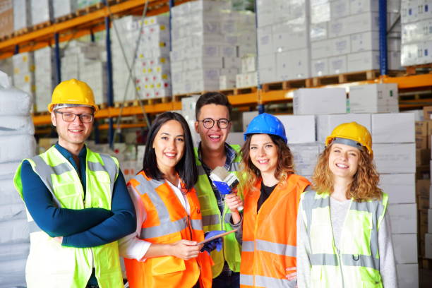 istock Group portrait of staff at distribution warehouse 945719398