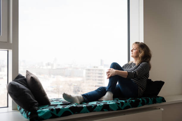 istock Woman relaxing with closed eyes at home 945732852