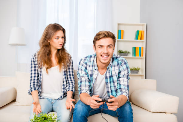 istock Young family with disagreements. Husband playing video games 945733348
