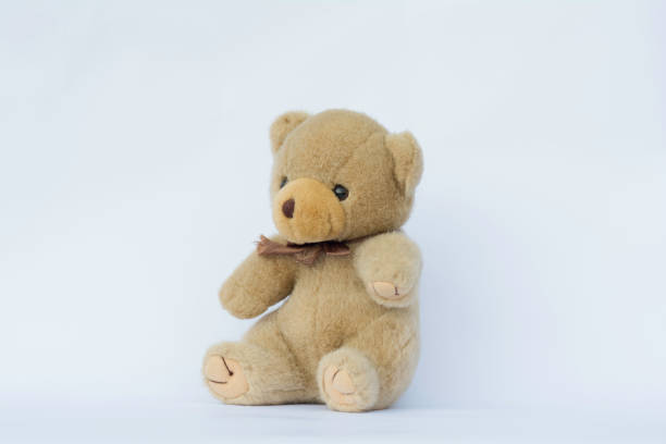 istock soft toy teddy bear  sitting on white background. 945739008