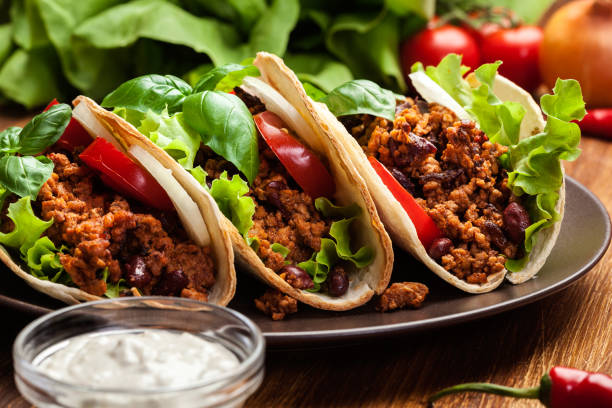 istock Mexican tacos with minced meat, beans and spices 945739416