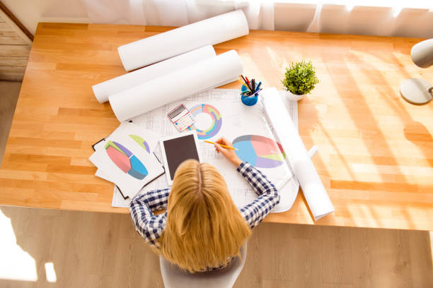 istock Top view of woman with tablet working on new project 945739516