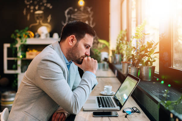 istock Thoughtful businessman looking at laptop screen 945746416