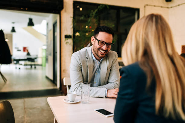 istock Dating concept. Smiling couple drinking coffee at cafe. 945746514
