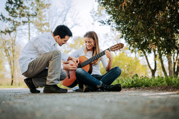 istock Guitar lesson outdoors. 945747826