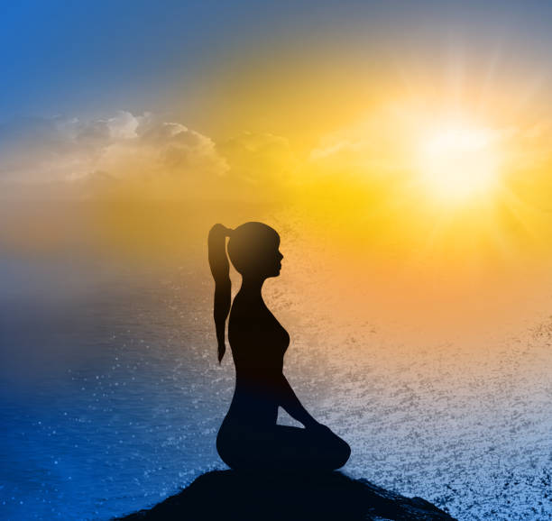 istock Yoga silhouette on the beach in sunrays. The dawn sun 945768778
