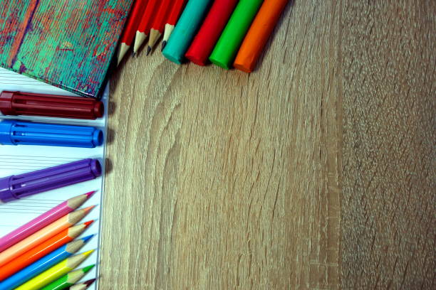 istock School desk with multicolored student`s supplies 945769474