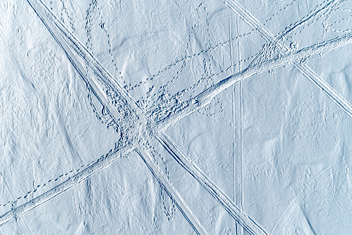 The bird's eye view. The snowy surface of the Volga with tracks and paths. The river in the middle reaches is covered with snow. Scenic white background