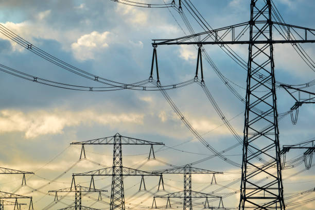 istock High voltage electricity pylons at sunset. 945773988