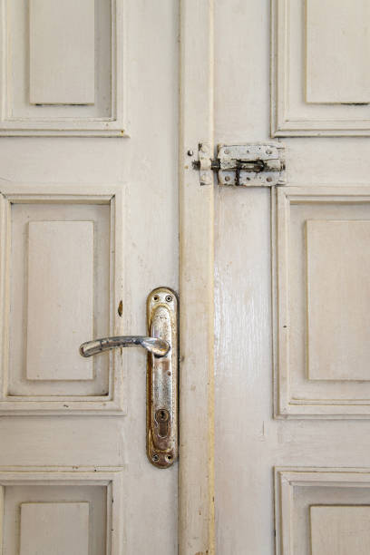 istock Close up of the old ancient door, security concept 945776990