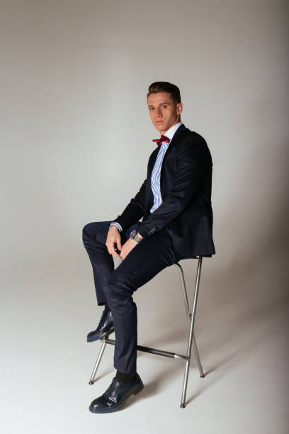 istock the guy in the suit is sitting on a chair 945777732