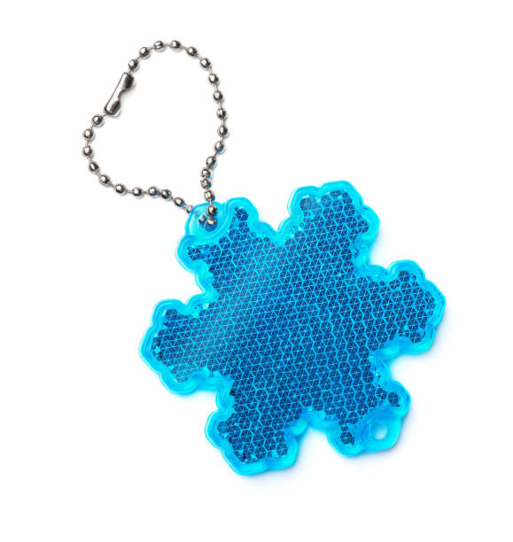 Safety reflector keyring Snowflake safety reflector keyring isolated on white reflector stock pictures, royalty-free photos & images