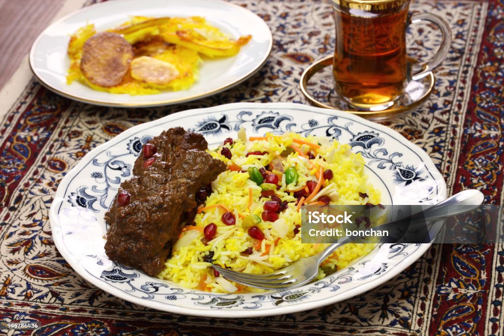 iranian persian cuisine iranian cuisine, persian jeweled rice and chicken fesenjan, potato tahdig Iran Stock Photo