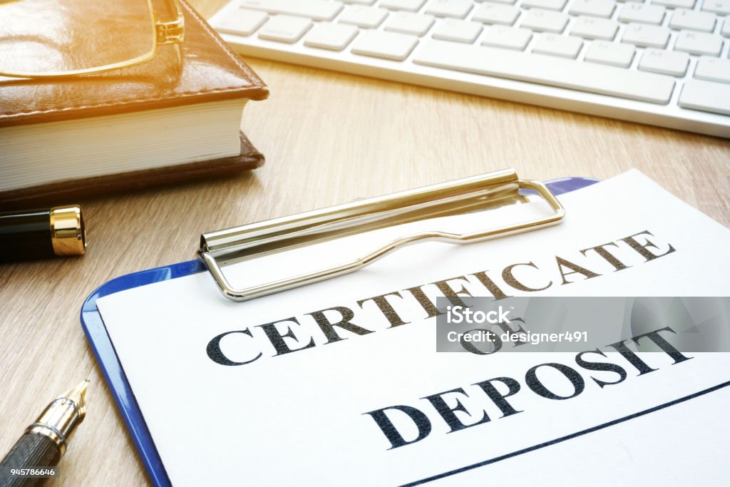 Certificate of deposit and pen on a desk. Bank Deposit Slip Stock Photo