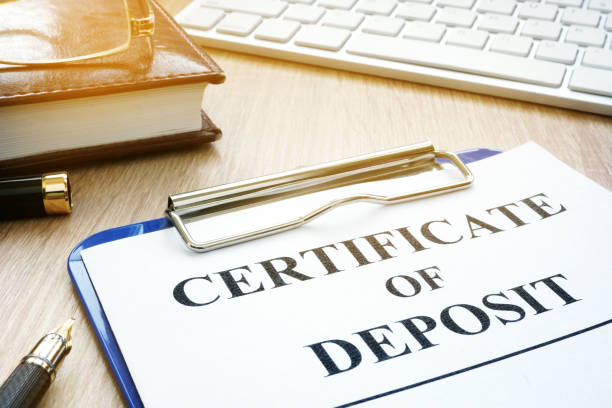 Certificate of deposit and pen on a desk. Certificate of deposit and pen on a desk. bank deposit slip stock pictures, royalty-free photos & images