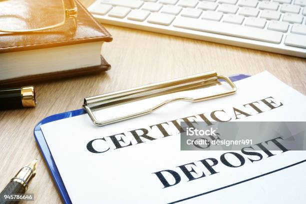 Certificate Of Deposit And Pen On A Desk Stock Photo - Download Image Now - Bank Deposit Slip, Certificate, Finance