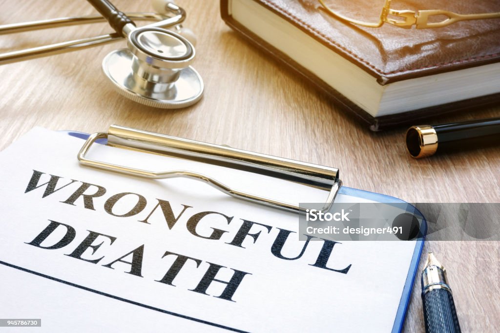 Wrongful death form and stethoscope on a table. Dead Stock Photo