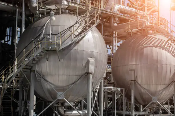 oil-refinery plant with Liquefied Natural Gas (LNG) storage tanks.