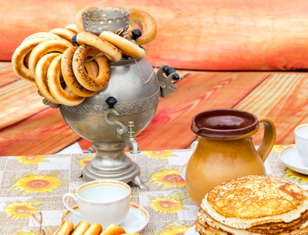 istock Traditional russian samovar with tasty bagels and ceramic tableware 945805396