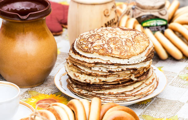 Stack of tasty fried pancakes and bagels on the table