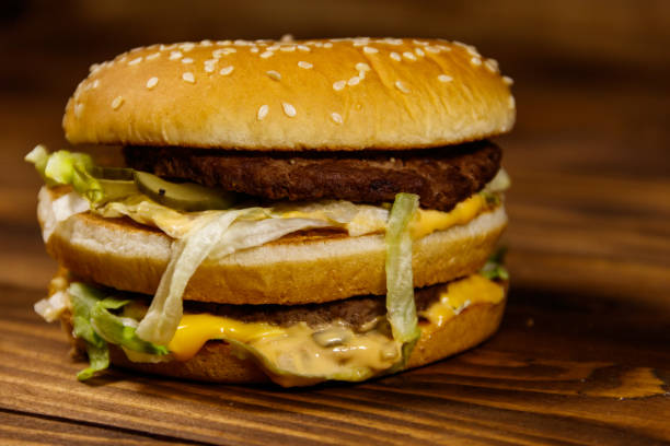 istock Delicious big hamburger on wooden table 945812258