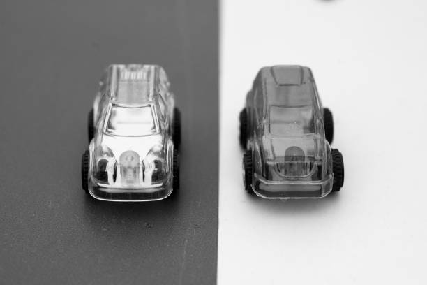 istock grey clear plastic model cars on contrasting tracks 945814098