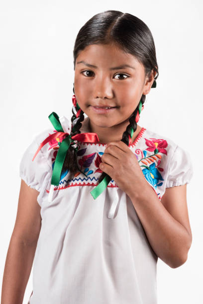 istock Hispanic girl with native embroidered blouse 945820360