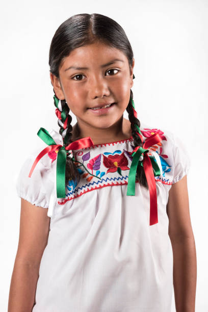 istock Hispanic girl with native embroidered blouse 945824592