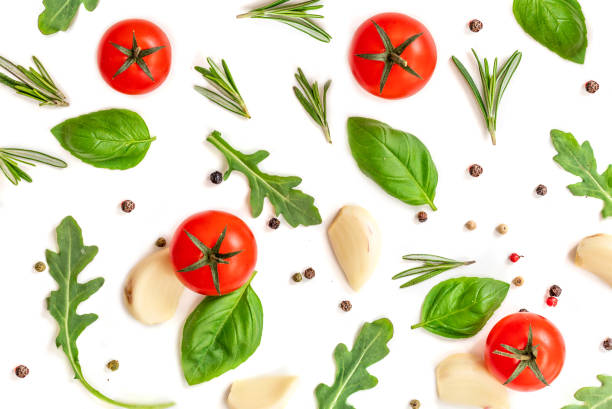 istock Tomato, garlic and basil isolated on white background, top view. Food pattern with fresh organic vegetables and spices. Flat lay. 945830370