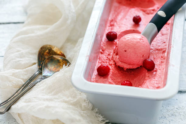 istock Cranberry ice cream and a spoon in a metal container. 945830902
