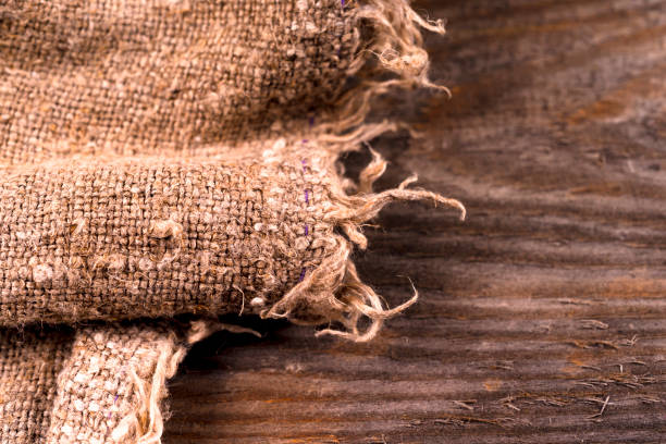 istock burlap hessian sacking on wooden background 945837900