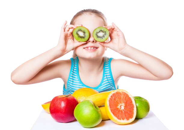 istock girl with fruits on a white background. 945838496