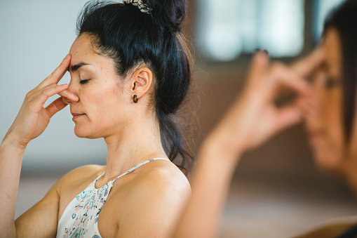 Pranayama breathing exercises. Women practicing yoga position