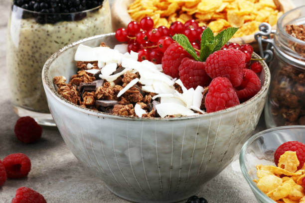 istock Cereal and ingredients for a healthy breakfast with chia pudding, granola, cornflakes and berries 945842062