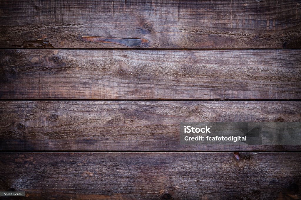 Old wooden plank Old weathered wood plank with horizontal stripes shot directly above. Useful copy space for text and/or logo. Predominant color is brown. Low key DSRL studio photo taken with Canon EOS 5D Mk II and EF 100mm f/2.8L Macro IS USM Wood - Material Stock Photo