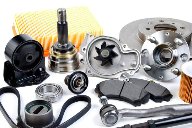 istock Auto parts background. Hub, pump, brake pads, filter, timing belt, rollers, constant velocity joints, thermostat and other on white background. Set of spare parts for repair 945849494