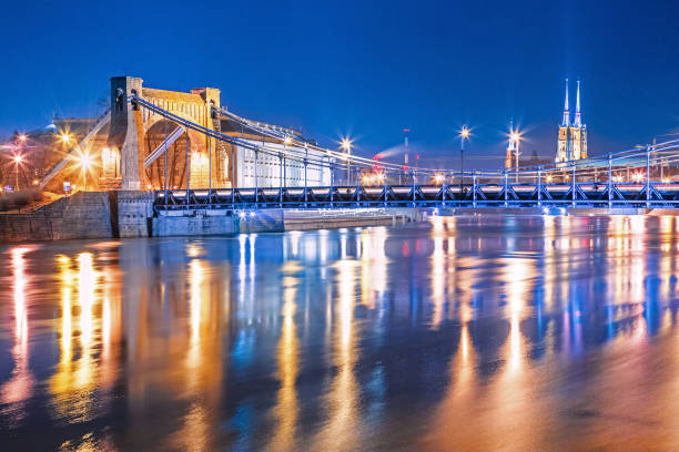 famous stone cable-stayed grunwaldzki bridge in wroclaw, poland, europe. breathtaking night scenery over oder river. - wroclaw traffic night flowing imagens e fotografias de stock