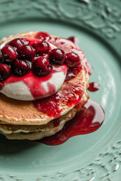 Delicious american pancakes on a green rustic plate