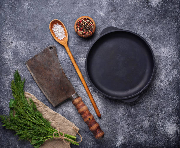 istock Culinary background with spices, pan and cleaver 945862920