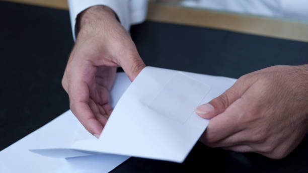 Businessman hands opening an envelope stock photo