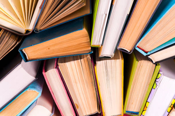 istock Open book, hardback books on bright colorful background. 945866764