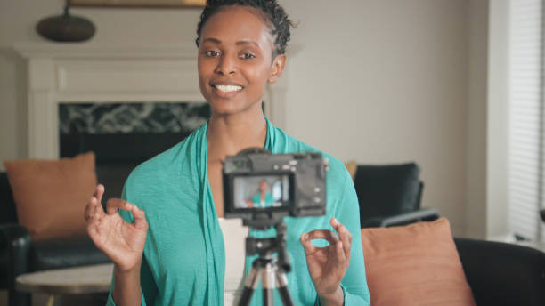 istock Beautiful African-American Vlogger Recording a Show 945870198