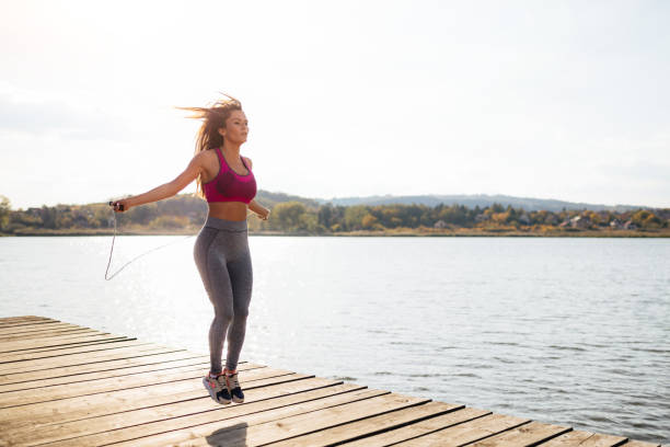 istock Fit young woman skipping a rope 945873880