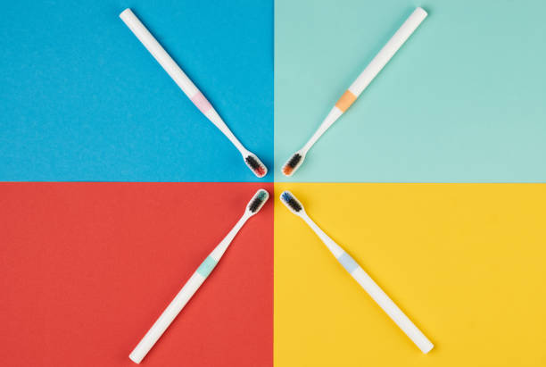 istock Colorful toothbrushes on four colored background 945874188