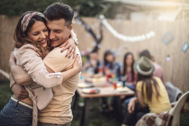 istock Love couple with friends having dinner party in backyard 945881082